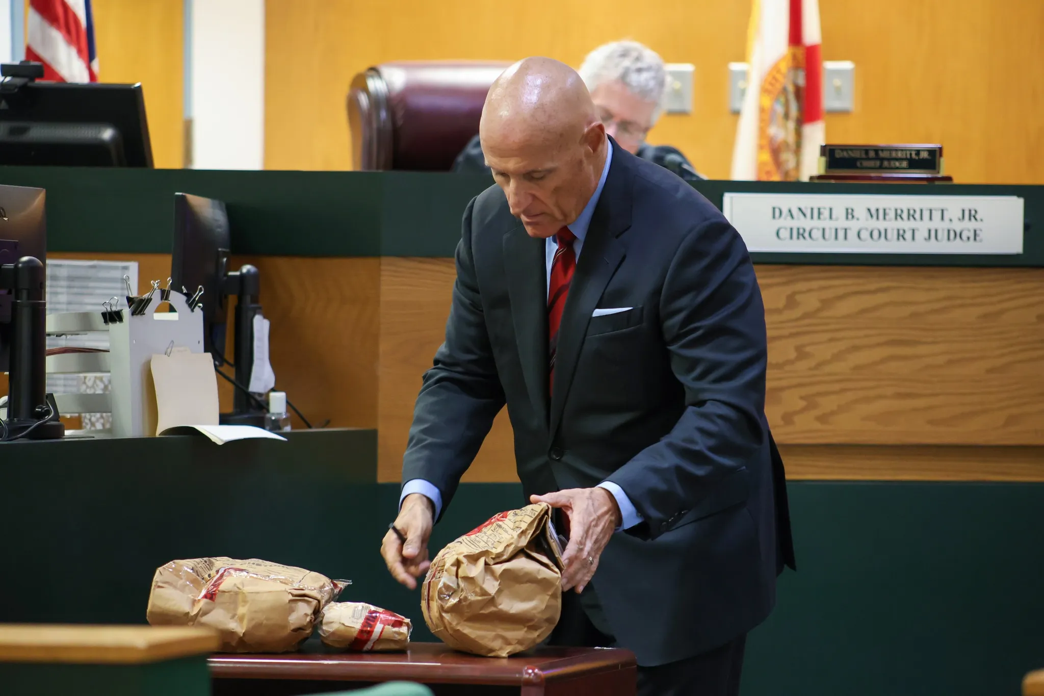 D. Robert Lewis handling evidence in a Hernando County courtroom